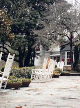 Blackberry Farm Tennessee -rocking chairs on a stone path outside the resort grounds.