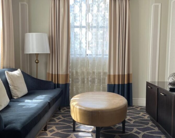 sitting room with couch, coffee table and television in a hotel room