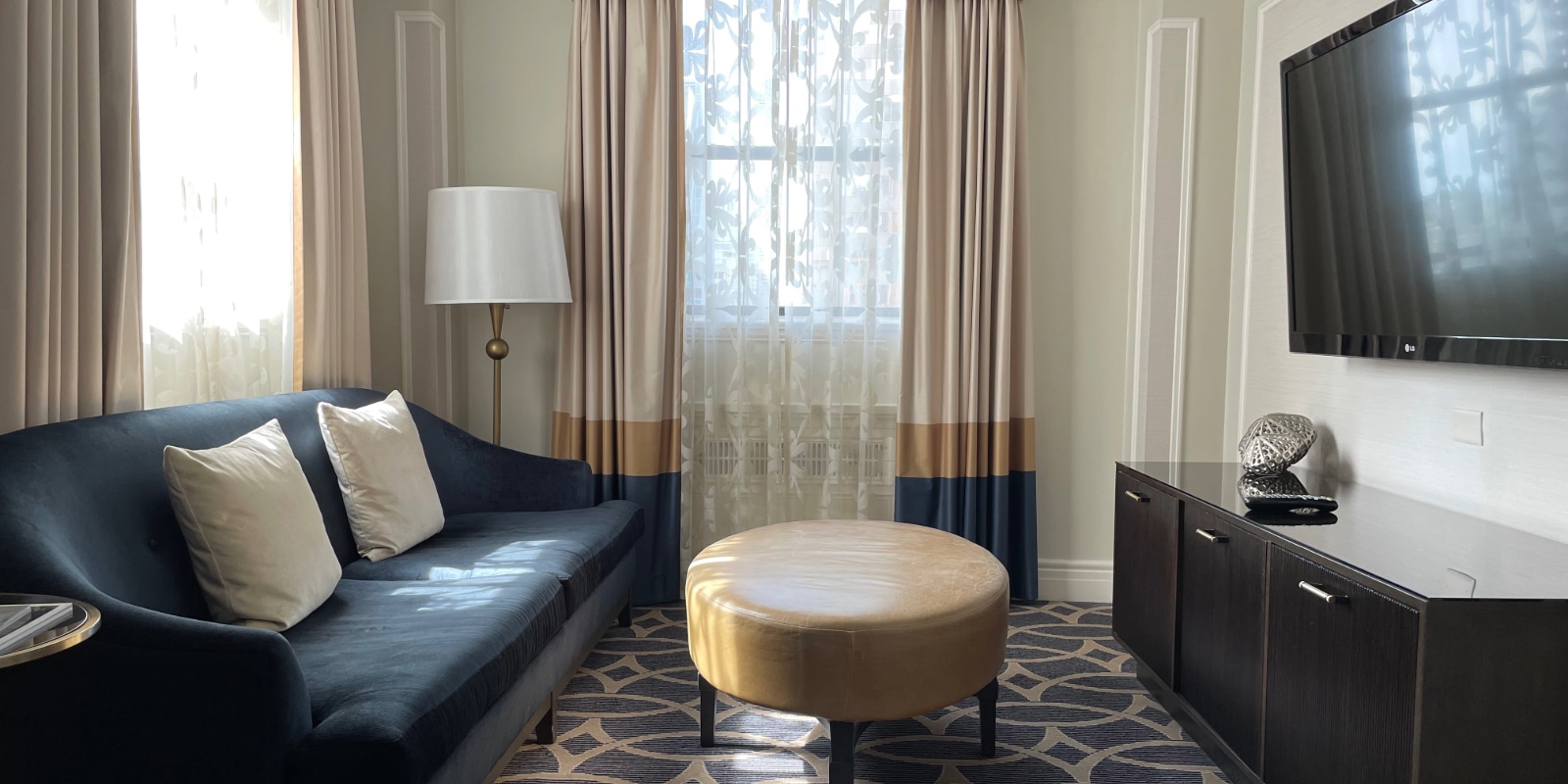 sitting room with couch, coffee table and television in a hotel room