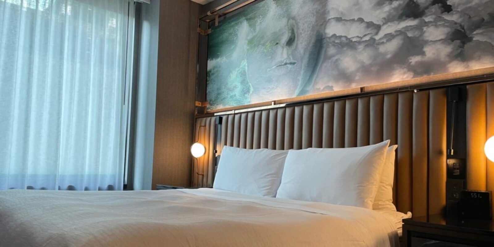 king bed beside a window in a hotel room