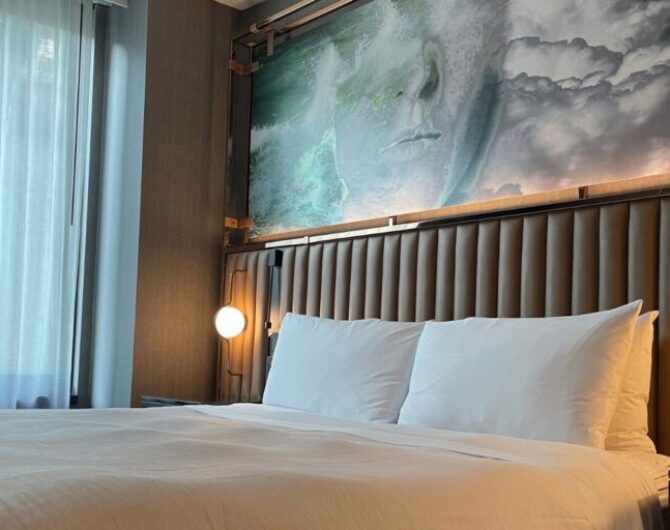 king bed beside a window in a hotel room