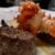 close up view of tenderloin steak topped with poached lobster tail