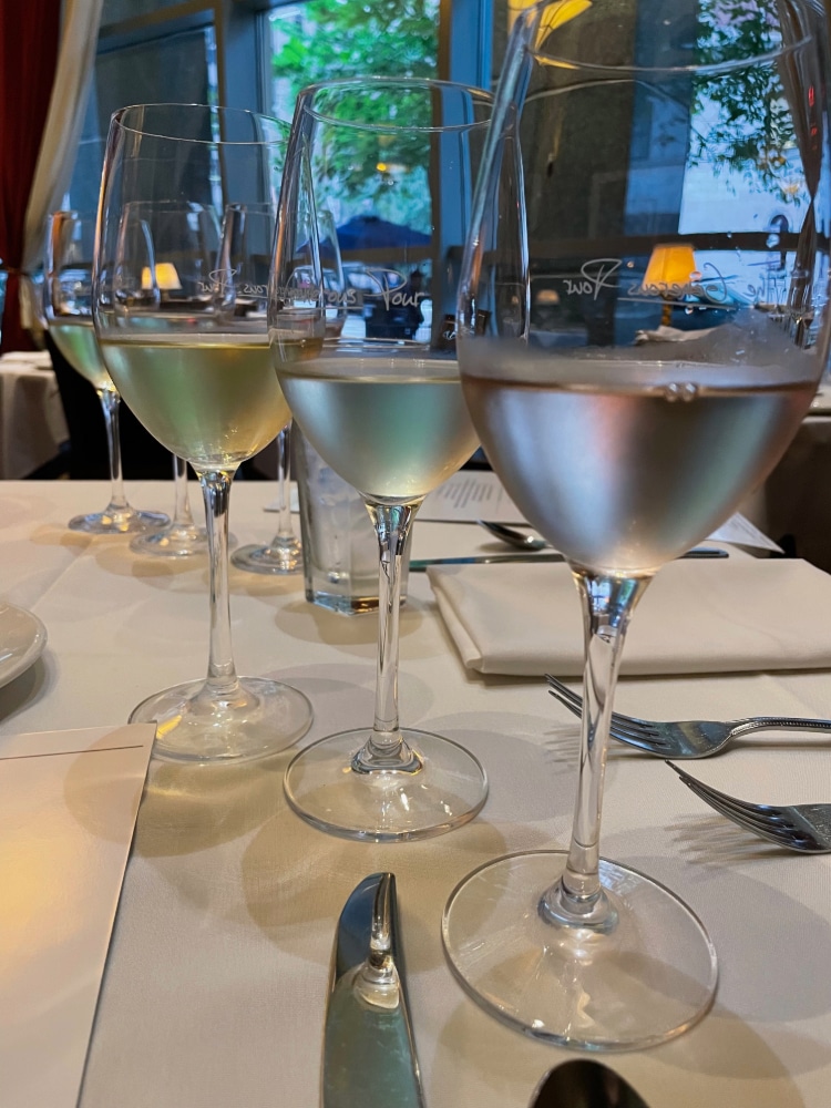 four glasses of white wine on a table