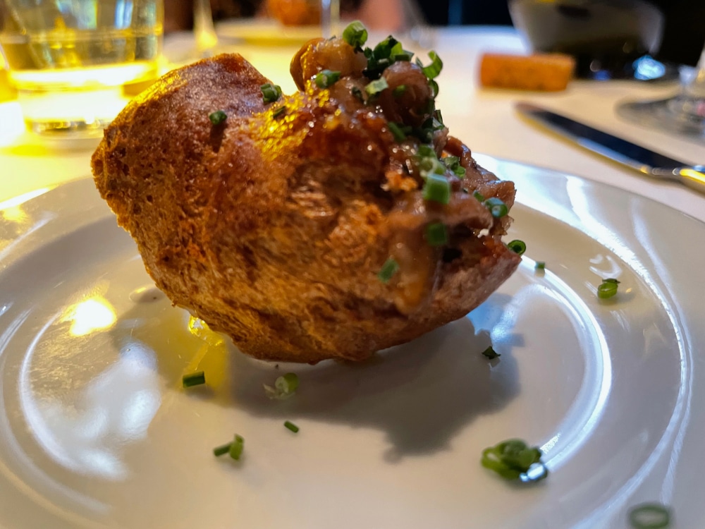 a prime rib puff pastry appetizer on a white plate