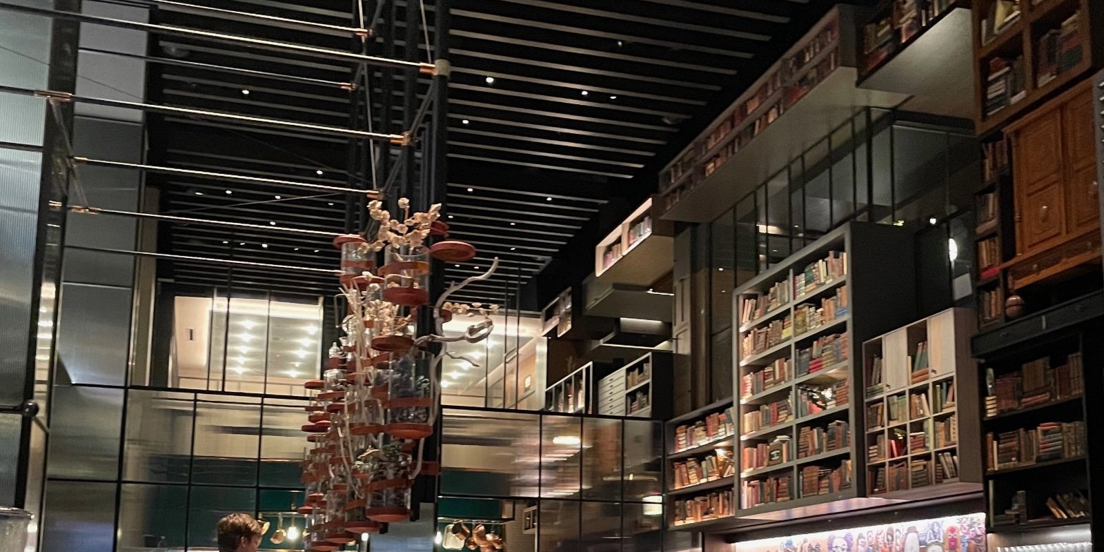 contemporary restaurant with a decorative wall of books
