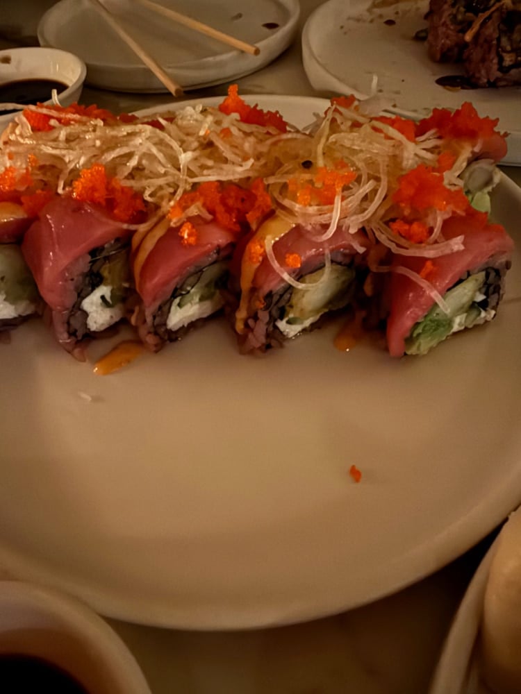tuna wrapped sushi roll on a white plate