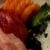 three kinds of sashimi with garnish on a white plate