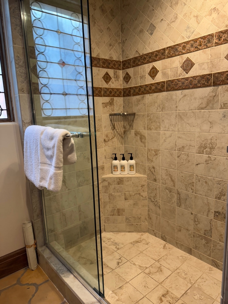 a glass-doored tiled shower