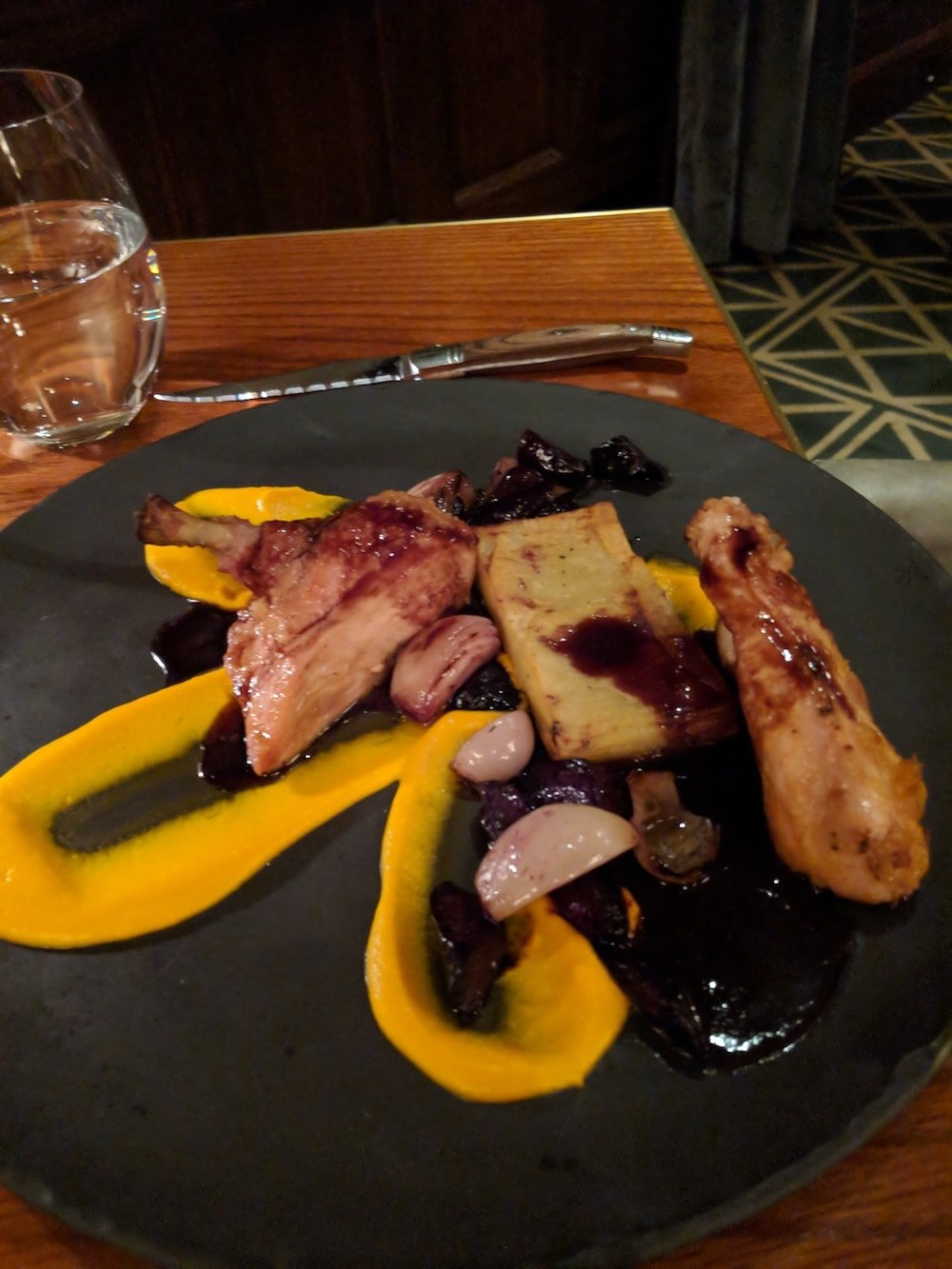 Roast Chicken Breast with carrot foam, charred shallots, and buttermilk potato pave.